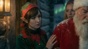 Christmas Elf girl comforting Santa